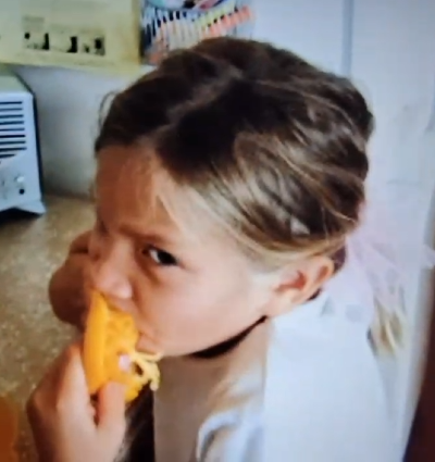 The spokesperson biting directly into an orange